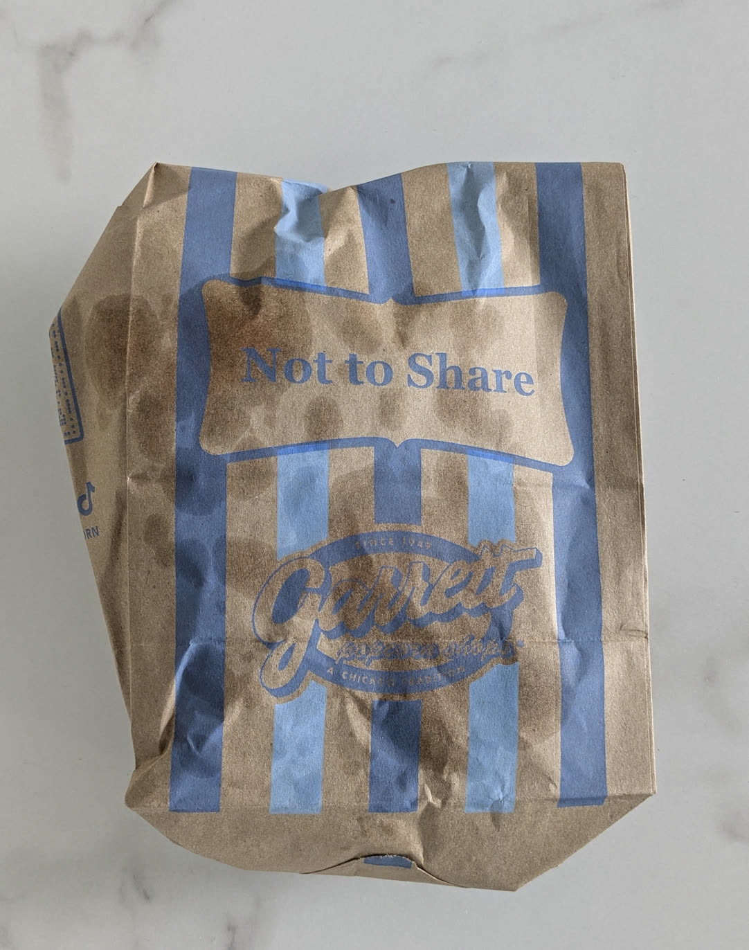 A striped Garrett Popcorn bag.